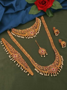 Alloy Jewel SetColor :MulticolorColor Code :NAModel Number :SHOPSY-5968Sales Package Id :1 Long Necklace, 1 Choker Necklace, 1 Pair Earrings, 1 Kamarband, 1 MaangtikkaType :Bridal SetBase Material :AlloyPlating :Gold-plated7 Days Return Policy, No questions asked.