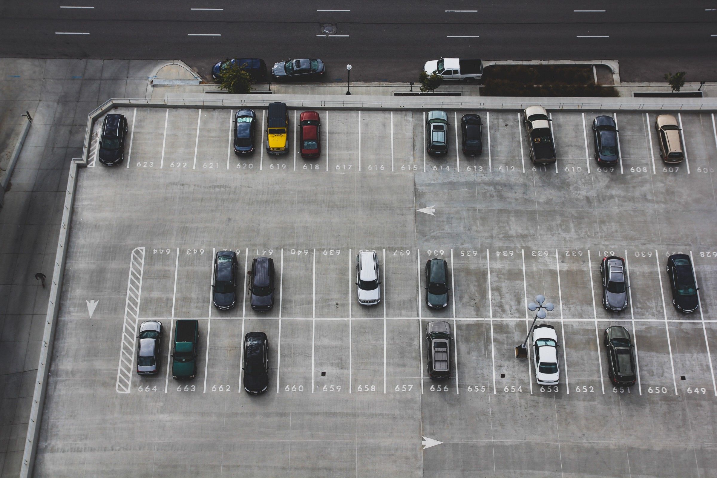 An aerial image of a half-empty parking lot.