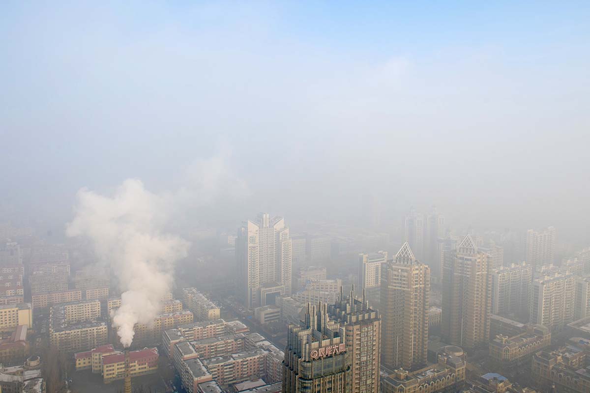 Photograph shows a city covered in smog