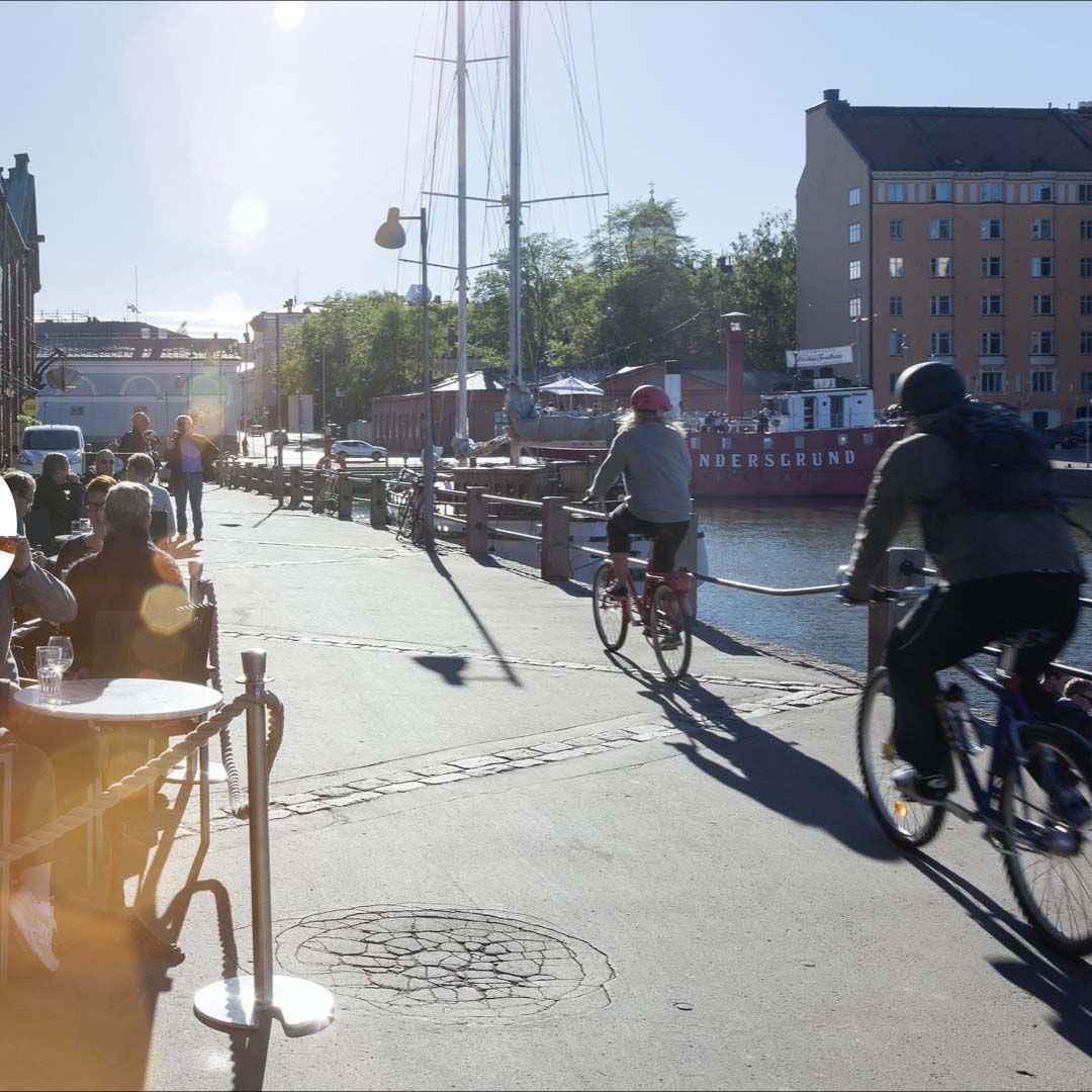 Cyclists riding along a sidewalk