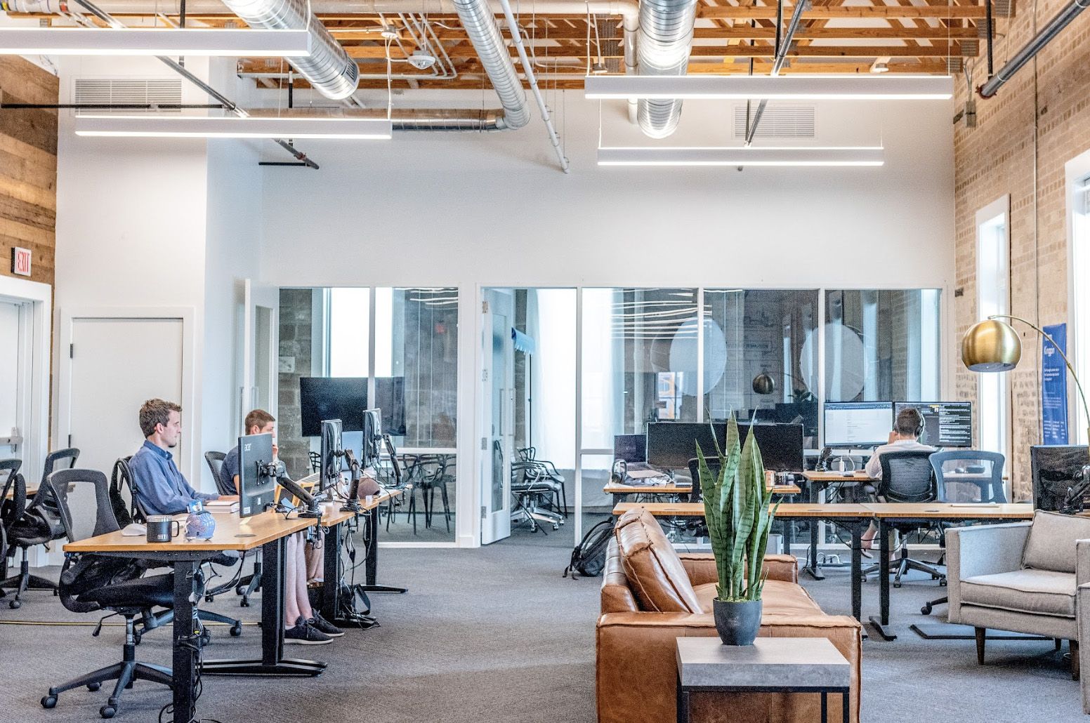 Employees working in a large, well-lit open office