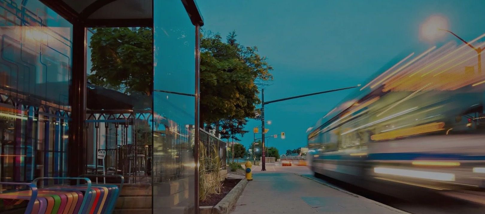 A bus drives by a bus stop