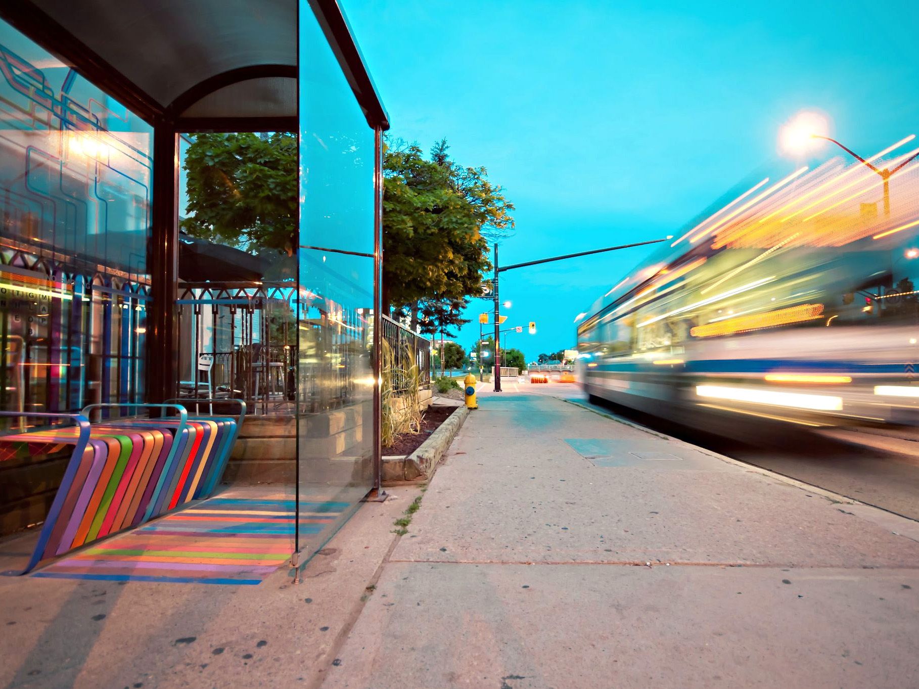 A bus drives by a bus stop