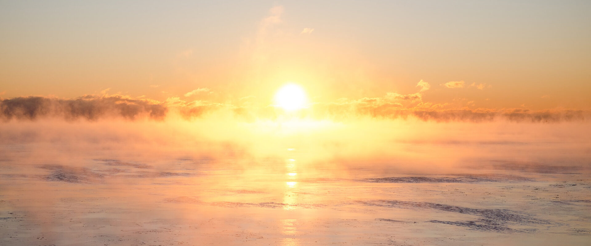 auringonlasku jäätyneen meren yllä