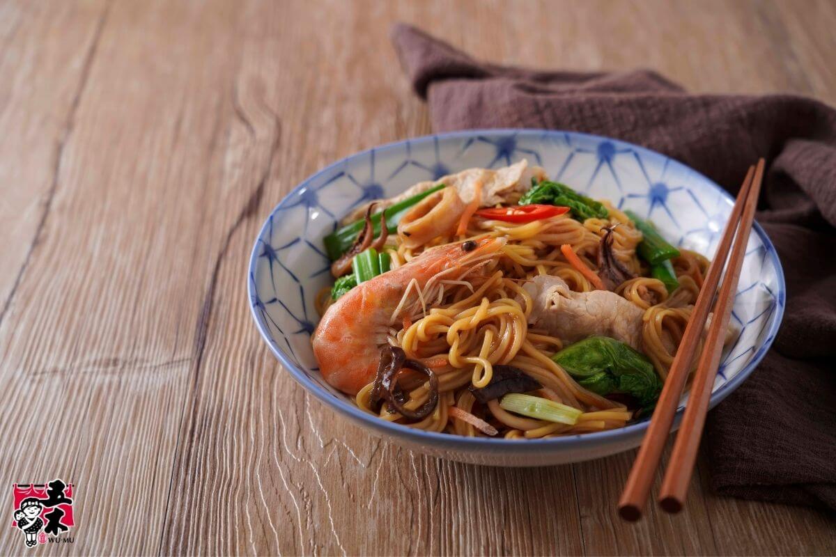 Stir-fried noodles with shrimp, sliced meat, vegetables, and mushrooms