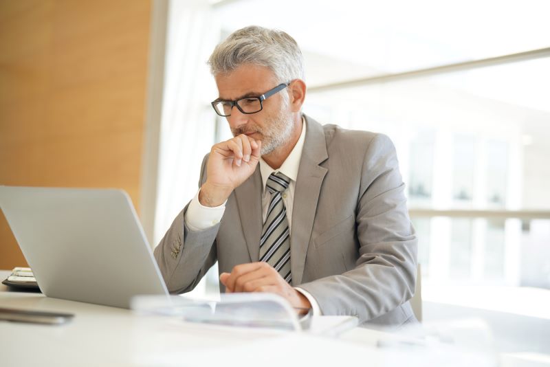 como cobrar um cliente​: homem trabalhando concentrado no escritório