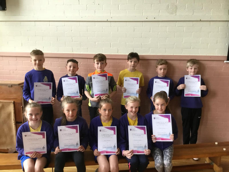Holy Trinity KS2 Cross Country runners receive their certificates