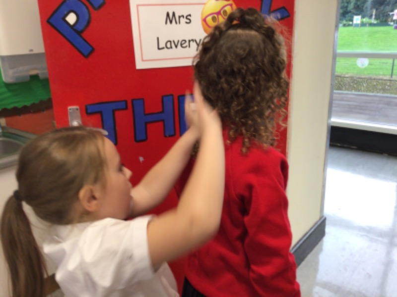 Using the palm of the hand to measure the height of each other.