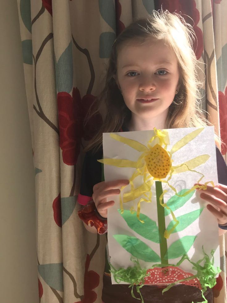 A sunflower collage using old pieces of paper and junk materials.