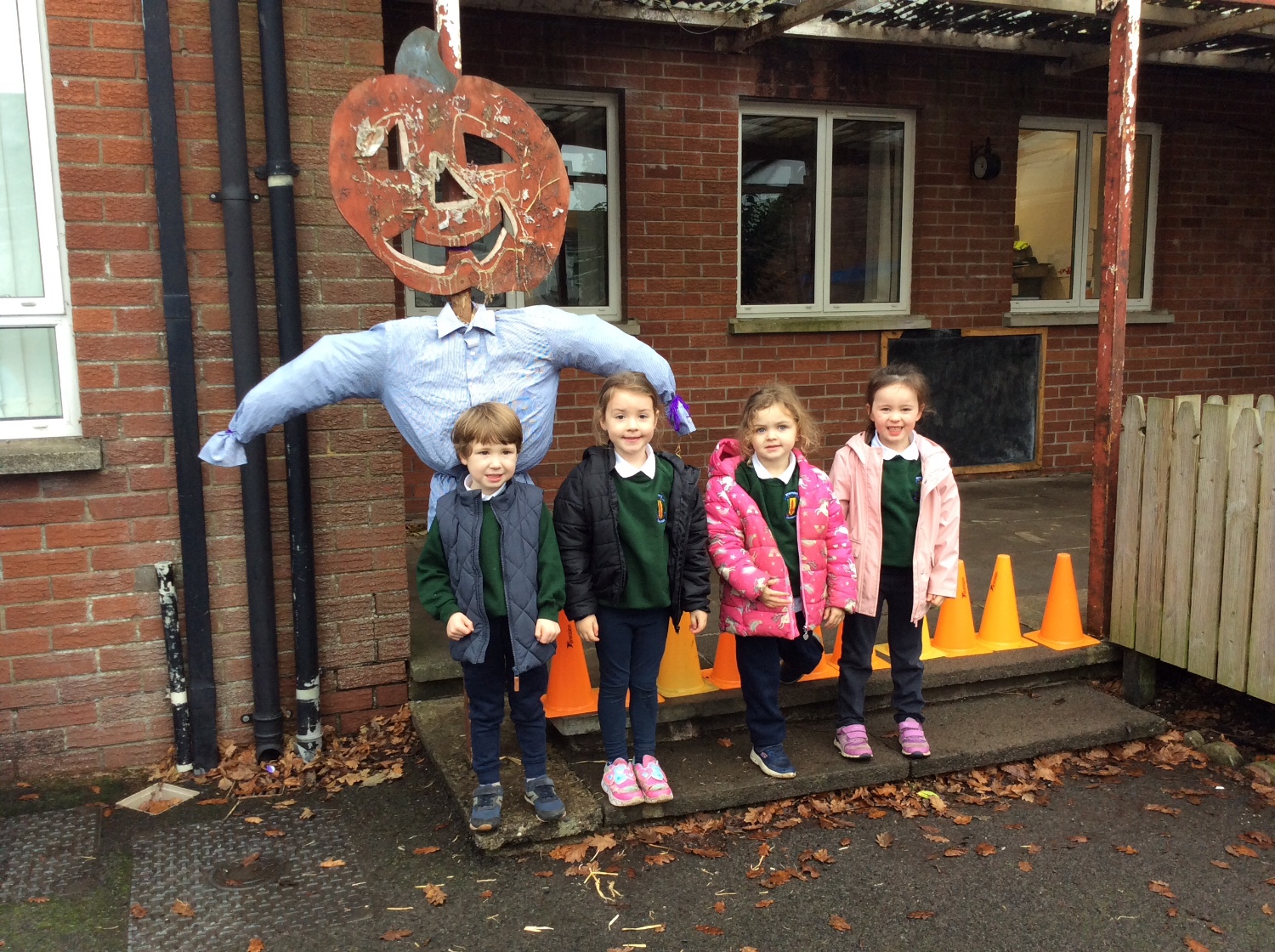Look at the Autumn scarecrow we made with straw and leaves.