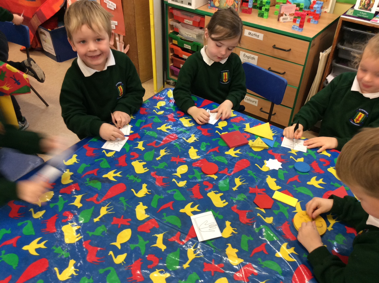 We use mirrors to look at the shapes and pictures in Symmetry.