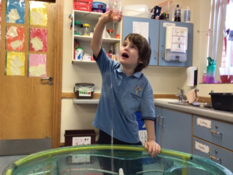 I am very engrossed in this water play activity, showing that I'm comfortable in my environment.