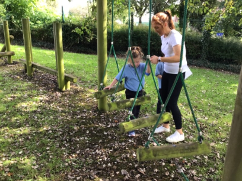 Staff model and support our pupils to build their confidence in taking on challenges, seen here at the Trim trail equipment.