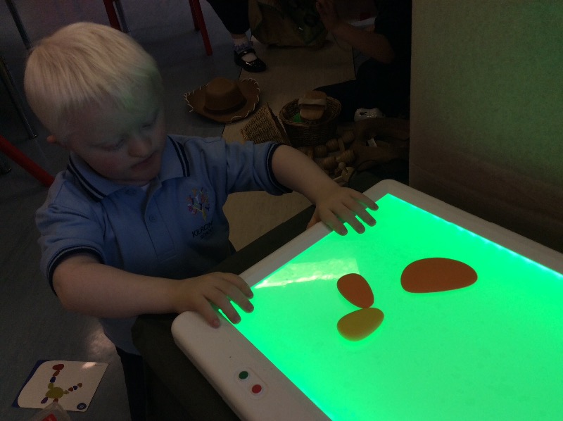 I'm exploring pebbles at the light table.
