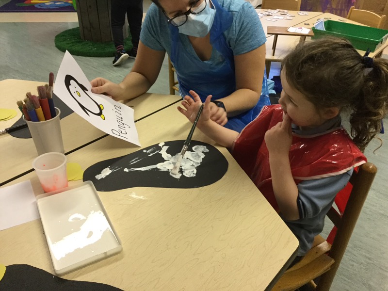 Using white paint to paint the body of my penguin.
