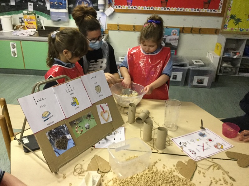 Mixing our lard and Cheerios together in a big bowl.