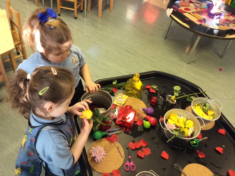Smelling the fresh flowers and putting them into our potion bottles.
