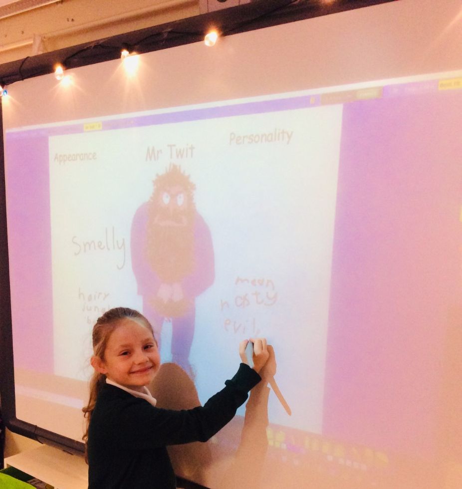 We are using the Interactive Whiteboard to develop our writing skills.
