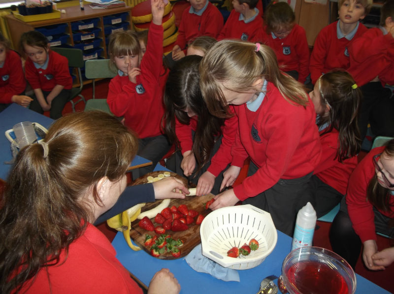 Carefully cutting more fruit