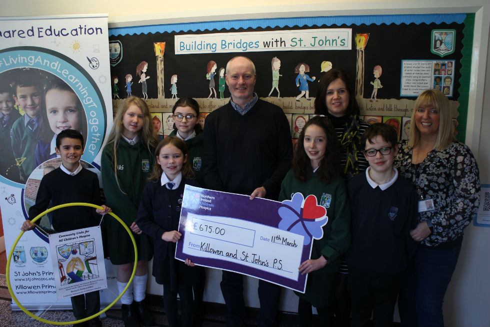 Mrs McDonnell, Mrs Moon and children from St. John's P.S. and Killowen P.S. present Mr. Damian McColgon with a cheque following our Shared Education Charity event. 