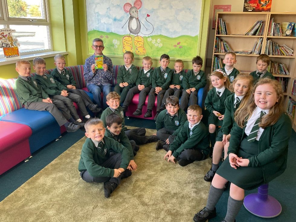 Enjoing a story read to them by member of staff from Waterstone's Coleraine to mark the official opening of our newly revamped library 