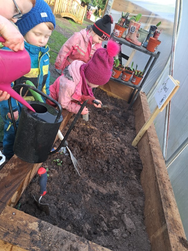 Watering cans and rakes