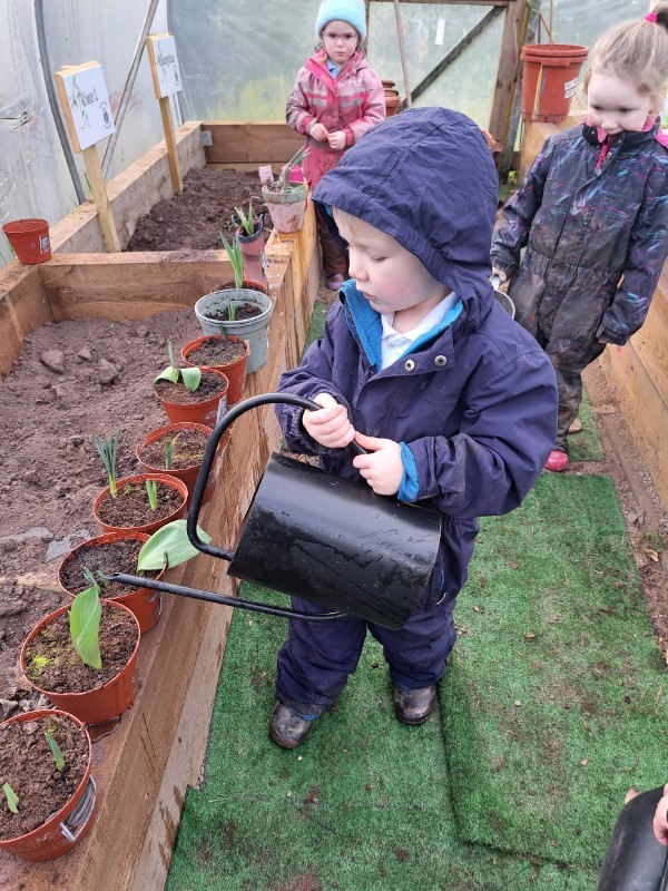 Watering cans and rakes