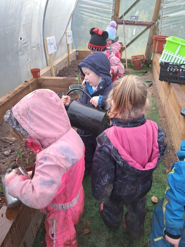 Watering cans and rakes