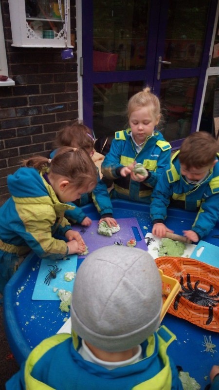 Green playdough with spiders!