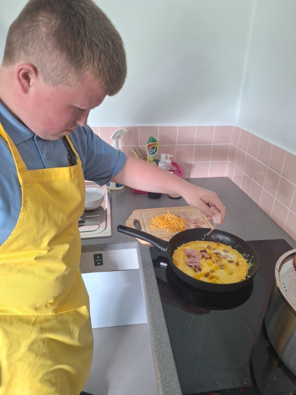 Jordan is adding fillings to his delicious omelette.