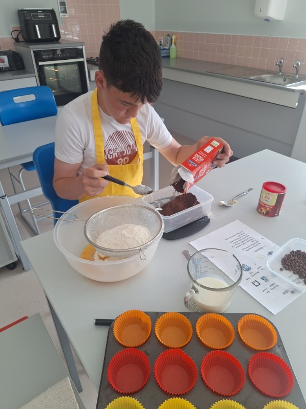 Shea is carefully measuring out the cocoa powder.