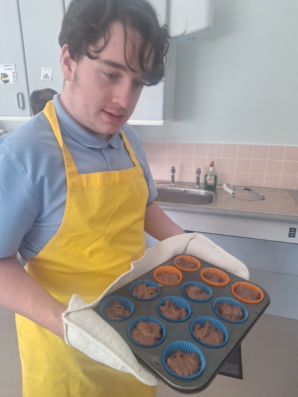 Roan is off to the oven with his chocolate chip muffins.