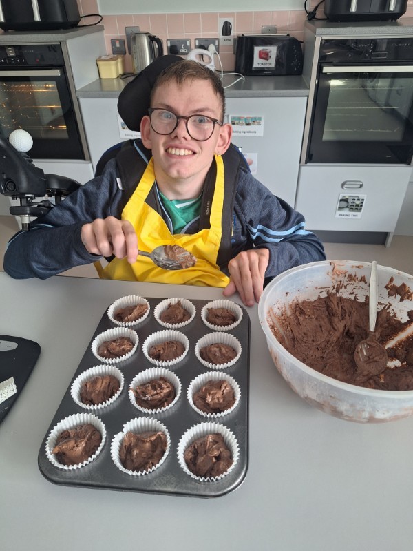 Paul is filling his muffin cases.