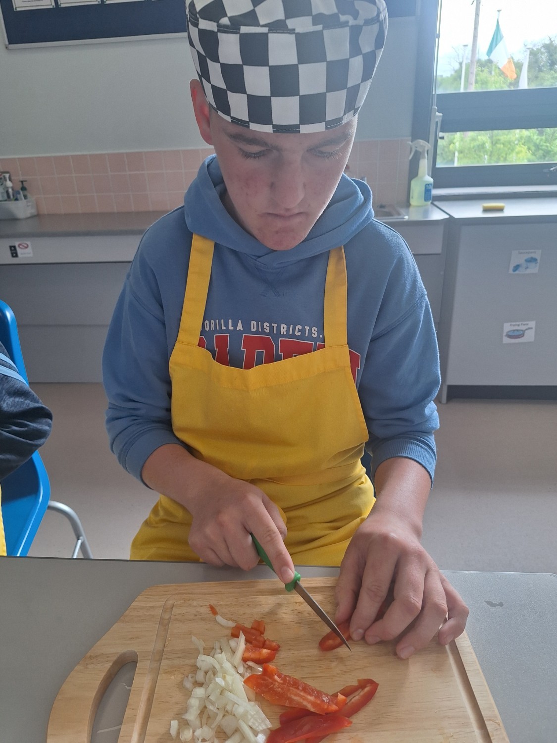 Shea is chopping vegetables for his omelette.