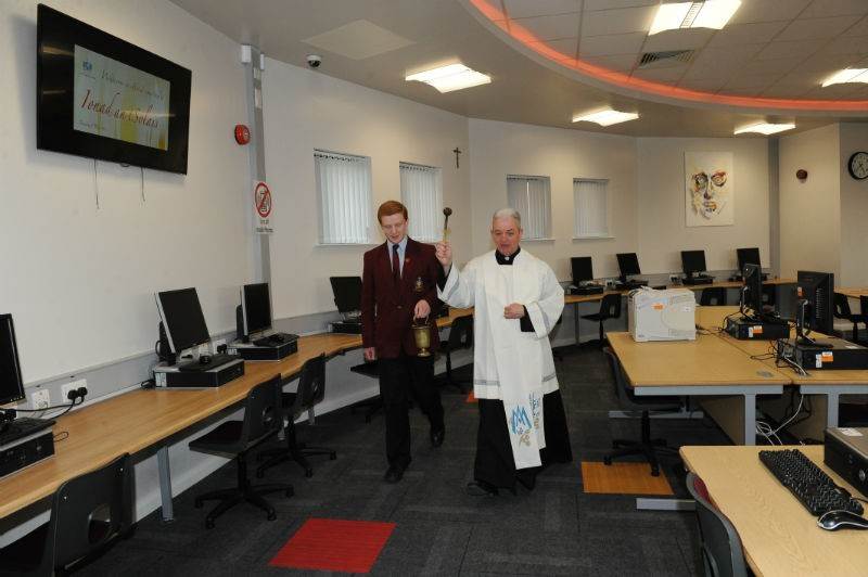 Fr Eamonn McCamley (School Governor) blessing Ionad an tSolais, assisted by Mark Fletcher (Head Boy).