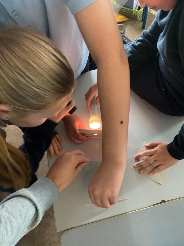 In Science, we work together in groups to carry out different investigations. Wecarried out experiments to learn all about light, how light travels and the different colours that white light is broken up into.