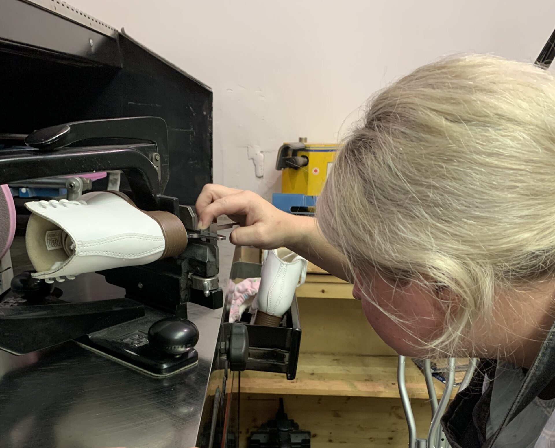 Sarah repairing skates at Skate of the Art