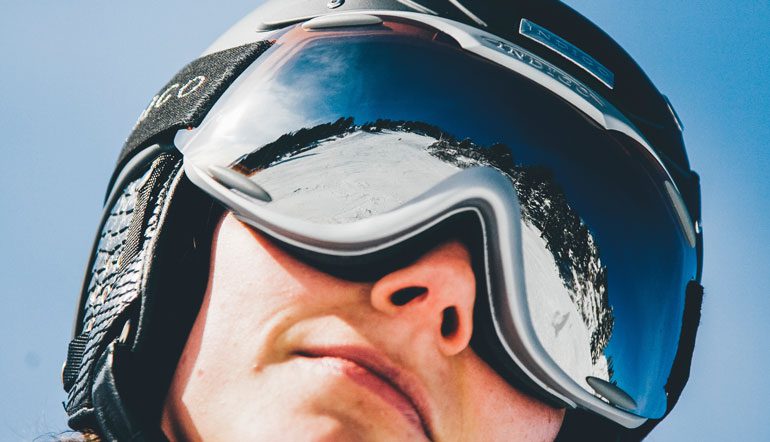 woman dressed for skiing in ski goggles