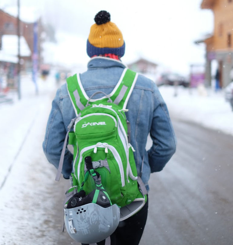 man wearing ski backpack and ski helmet