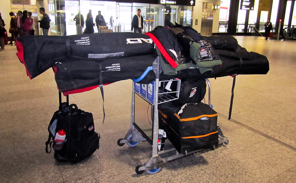 Ski bags and luggage on airport luggage trolley