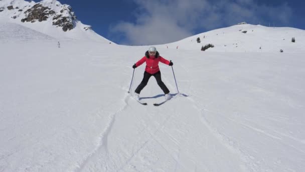 Woman snowplows on skis
