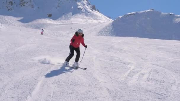 Woman skiing on groomed slope