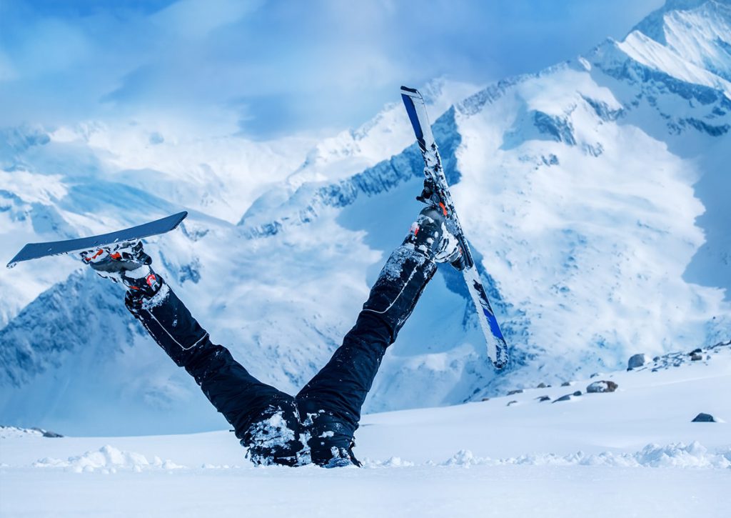 skier stuck in snow with legs in air