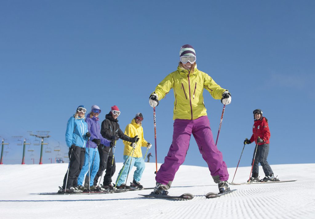 Woman have beginner group ski lesson