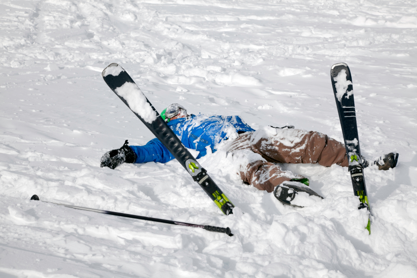 Skier on the ground covered in snow after falling