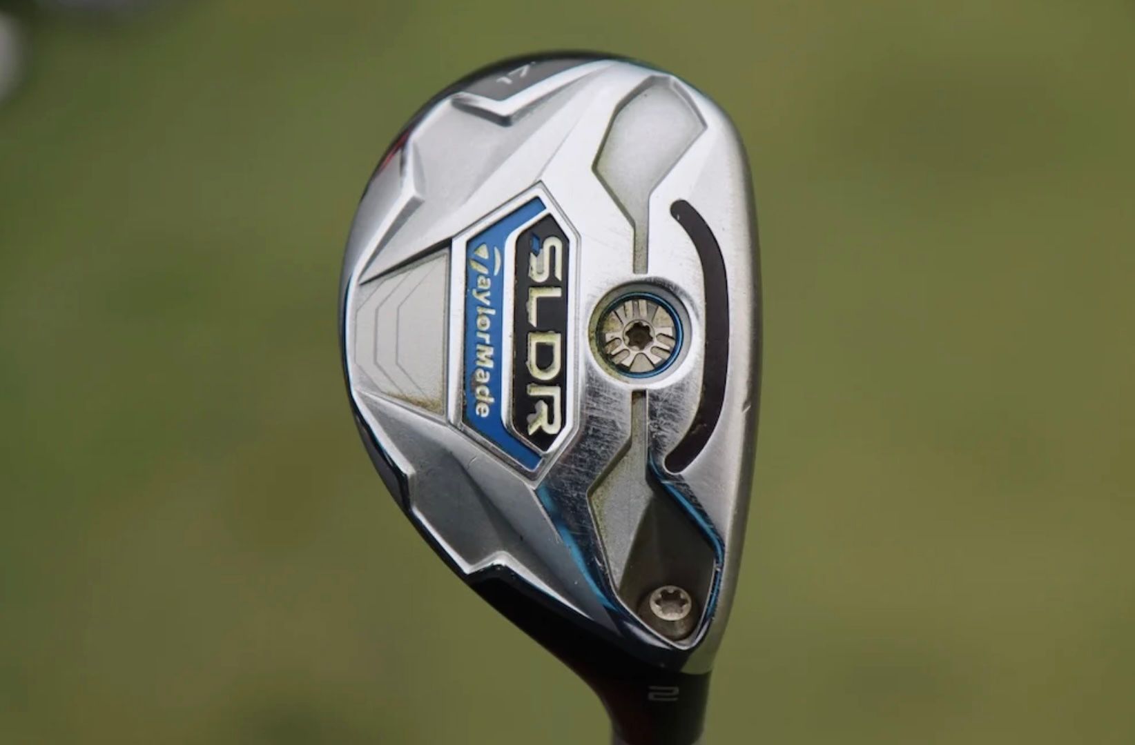 Silver and black golf hybrid club head with "GLOIRE" text and blue accents.