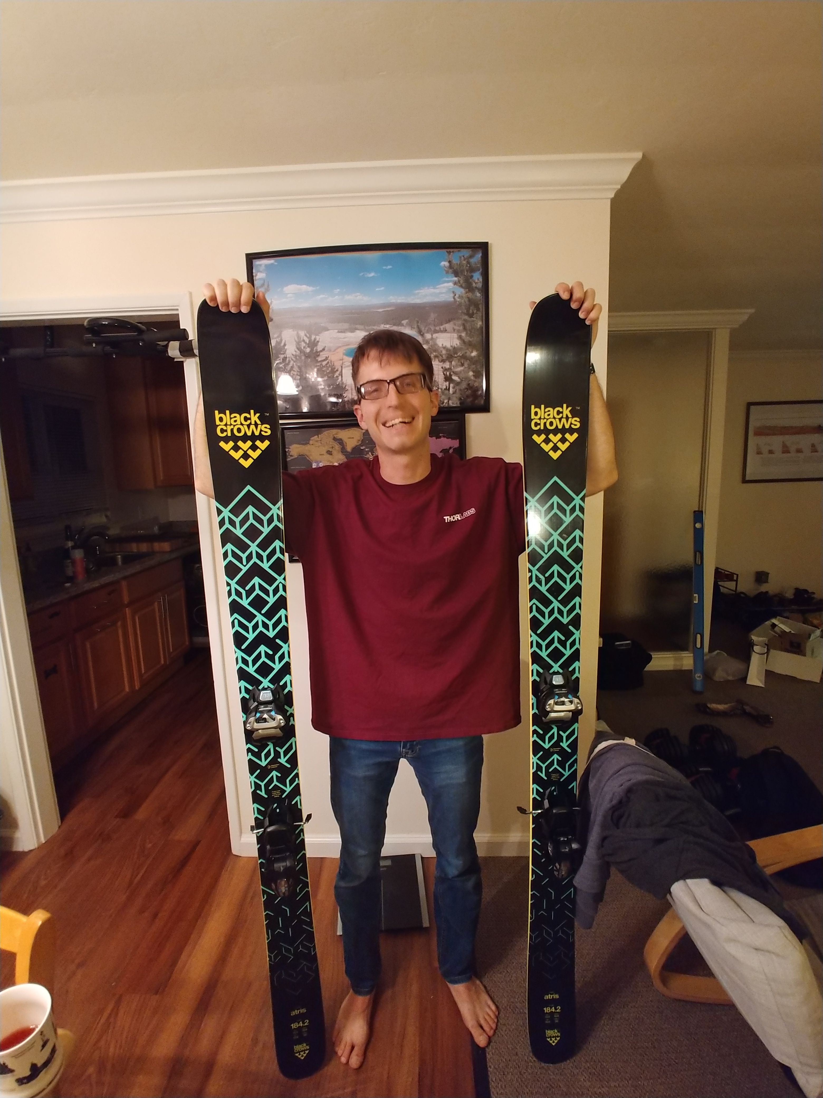 picture of Peter smiling broadly with skis