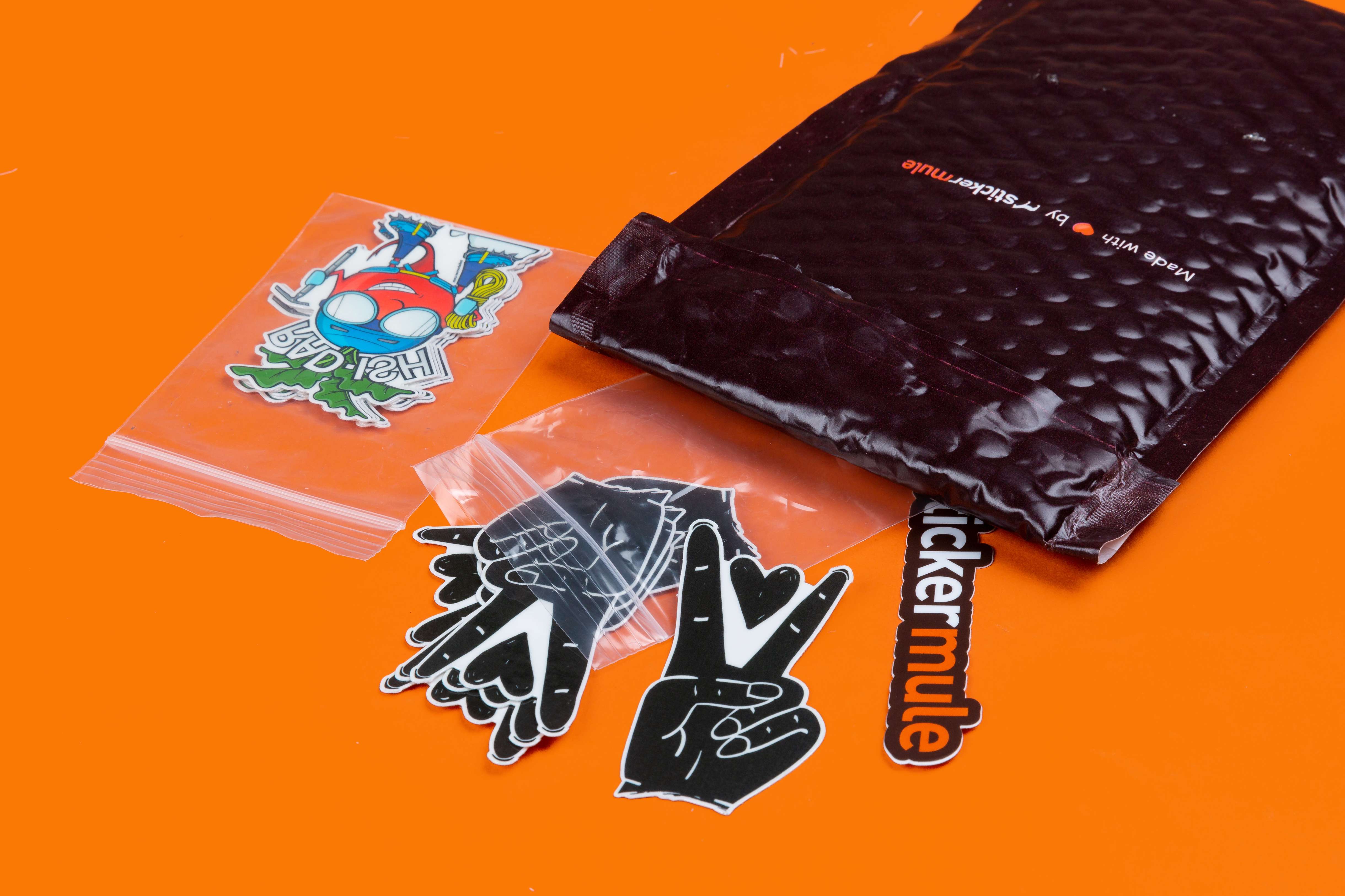 custom temporary tattoos packaged in small zip lock bags on an orange background