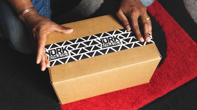 Black and white packaging tape design on a brown kraft box.