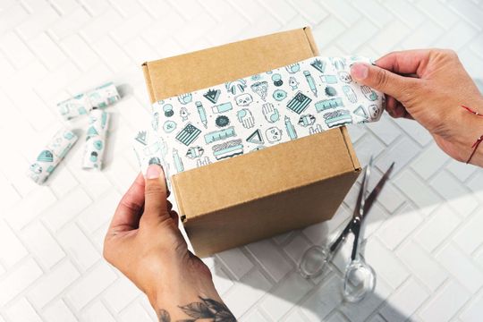 White packaging tape on a kraft box.